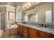 Bathroom with granite double vanity, large mirror, and soaking tub at 110 Golf Terrace Dr, Stockbridge, GA 30281