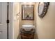 Small powder room with pedestal sink and ornate mirror at 110 Golf Terrace Dr, Stockbridge, GA 30281