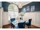 Formal dining room with a glass table and blue velvet chairs at 110 Golf Terrace Dr, Stockbridge, GA 30281