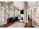 Bright living room with a fireplace and hardwood floors, leading to other rooms at 110 Golf Terrace Dr, Stockbridge, GA 30281