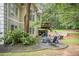 Stone patio with firepit and seating area near wooded area at 110 Golf Terrace Dr, Stockbridge, GA 30281