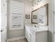 Bathroom with white vanity, copper mirror, and window at 191 Foxtail Rd, Woodstock, GA 30188