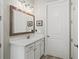 Bathroom with white vanity, copper accents, and a large mirror at 191 Foxtail Rd, Woodstock, GA 30188