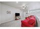 Bright loft sitting area, featuring a comfortable red couch at 191 Foxtail Rd, Woodstock, GA 30188