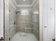 Large walk-in shower with tiled walls and a built-in seat at 191 Foxtail Rd, Woodstock, GA 30188