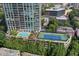 High rise building with tennis court and pool; lush green surroundings at 2795 Peachtree Rd # 1305, Atlanta, GA 30305