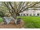 Relax in the green backyard with Adirondack chairs under the shade of mature trees at 2795 Peachtree Rd # 1305, Atlanta, GA 30305