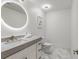 Modern bathroom with a sleek round mirror, stone vanity, and herringbone tile at 2795 Peachtree Rd # 1305, Atlanta, GA 30305