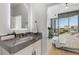 Modern bathroom features a sleek vanity with a marble countertop and city views from the bedroom at 2795 Peachtree Rd # 1305, Atlanta, GA 30305