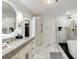 Spacious bathroom with double sinks, bathtub and glass shower with modern fixtures and tile at 2795 Peachtree Rd # 1305, Atlanta, GA 30305