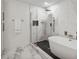 Bathroom with modern glass shower and large white tub at 2795 Peachtree Rd # 1305, Atlanta, GA 30305
