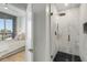 Bathroom with marble shower and city views from the bedroom's sliding glass doors at 2795 Peachtree Rd # 1305, Atlanta, GA 30305