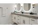 Bathroom with double sinks, grey countertops, white cabinets, modern fixtures, and marble floors at 2795 Peachtree Rd # 1305, Atlanta, GA 30305