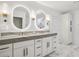 Elegant bathroom featuring double vanity, marble tile, and LED backlit mirrors at 2795 Peachtree Rd # 1305, Atlanta, GA 30305