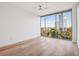 Bright bedroom featuring hardwood floors and large windows with city views at 2795 Peachtree Rd # 1305, Atlanta, GA 30305