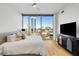 Bedroom featuring a large window, modern furniture and light hardwood floors at 2795 Peachtree Rd # 1305, Atlanta, GA 30305
