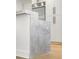 A kitchen's island with unique stone is shown in front of white cabinets and stainless steel appliances at 2795 Peachtree Rd # 1305, Atlanta, GA 30305