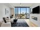 A city view shines through expansive windows in the living room with a modern design at 2795 Peachtree Rd # 1305, Atlanta, GA 30305