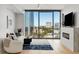 A spacious living room features a stunning city view and a modern fireplace at 2795 Peachtree Rd # 1305, Atlanta, GA 30305