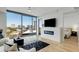 Bright living room featuring fireplace, city views, and an open doorway to the main bedroom at 2795 Peachtree Rd # 1305, Atlanta, GA 30305