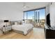 Inviting main bedroom featuring city views, ceiling fan, a large window, and modern decor at 2795 Peachtree Rd # 1305, Atlanta, GA 30305