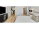 Bright main bedroom boasts modern decor, hardwood floors, and a convenient doorway to the kitchen at 2795 Peachtree Rd # 1305, Atlanta, GA 30305