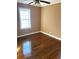 Simple bedroom with hardwood floors and large window at 708 South Ave, Forest Park, GA 30297