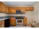 Stainless steel appliances and wood cabinets in kitchen at 120 Paces Lakes Pt, Dallas, GA 30157