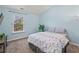 Light blue bedroom with a queen bed and window at 1227 Clear Stream Rdg, Auburn, GA 30011