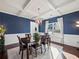 Formal dining room with blue walls, coffered ceiling, and hardwood floors at 1227 Clear Stream Rdg, Auburn, GA 30011