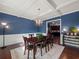 Formal dining room with blue walls, coffered ceiling, and hardwood floors at 1227 Clear Stream Rdg, Auburn, GA 30011