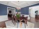 Formal dining room with blue walls, coffered ceiling, and hardwood floors at 1227 Clear Stream Rdg, Auburn, GA 30011