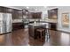 Modern kitchen with dark brown cabinetry, granite countertops, and stainless steel appliances at 1227 Clear Stream Rdg, Auburn, GA 30011