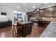 Spacious kitchen with granite countertops, stainless steel appliances, and dark wood cabinets at 1227 Clear Stream Rdg, Auburn, GA 30011