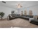 Large living room with sectional sofa, great natural light, and view of kitchen at 1227 Clear Stream Rdg, Auburn, GA 30011