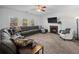 Relaxing living room with sectional sofa, fireplace, and hardwood floors at 1227 Clear Stream Rdg, Auburn, GA 30011