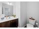 Small powder room with dark brown vanity and white toilet at 1227 Clear Stream Rdg, Auburn, GA 30011