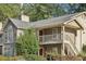 Tan two-story condo with a red door, wooden stairs, and landscaping at 2408 Country Park Se Dr, Smyrna, GA 30080