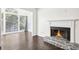 Living room with fireplace, dark hardwood floors, and sunroom view at 2408 Country Park Se Dr, Smyrna, GA 30080