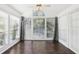 Bright sunroom with dark hardwood floors and many windows at 2408 Country Park Se Dr, Smyrna, GA 30080