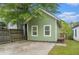 Green house exterior with a small deck and fenced yard at 490 Rockwell Sw St, Atlanta, GA 30310