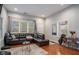 Spacious living room featuring hardwood floors and a large sectional sofa at 490 Rockwell Sw St, Atlanta, GA 30310