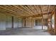 Unfinished basement space featuring exposed insulation and wooden beams at 6935 Melody Dr, Buford, GA 30518