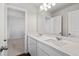 Bright bathroom with double sinks, modern lighting, and a large mirror over the vanity at 6935 Melody Dr, Buford, GA 30518