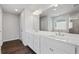 Beautiful bathroom featuring double vanity with white cabinets, sleek fixtures, and a large mirror at 6935 Melody Dr, Buford, GA 30518