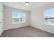 Bedroom features carpet flooring and two large windows at 6935 Melody Dr, Buford, GA 30518