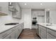 Stylish kitchen featuring gray cabinets, stainless steel appliances, and modern countertops with a kitchen island at 6935 Melody Dr, Buford, GA 30518