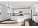 Bright kitchen featuring white cabinets, stainless steel appliances, dark countertops, and a central island at 6935 Melody Ridge Rd, Buford, GA 30518