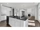 Kitchen island with a sink overlooking a spacious living area, creating an inviting, open-concept space at 6935 Melody Dr, Buford, GA 30518