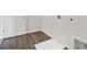 Laundry area with wood-look flooring and hookups at 6935 Melody Dr, Buford, GA 30518